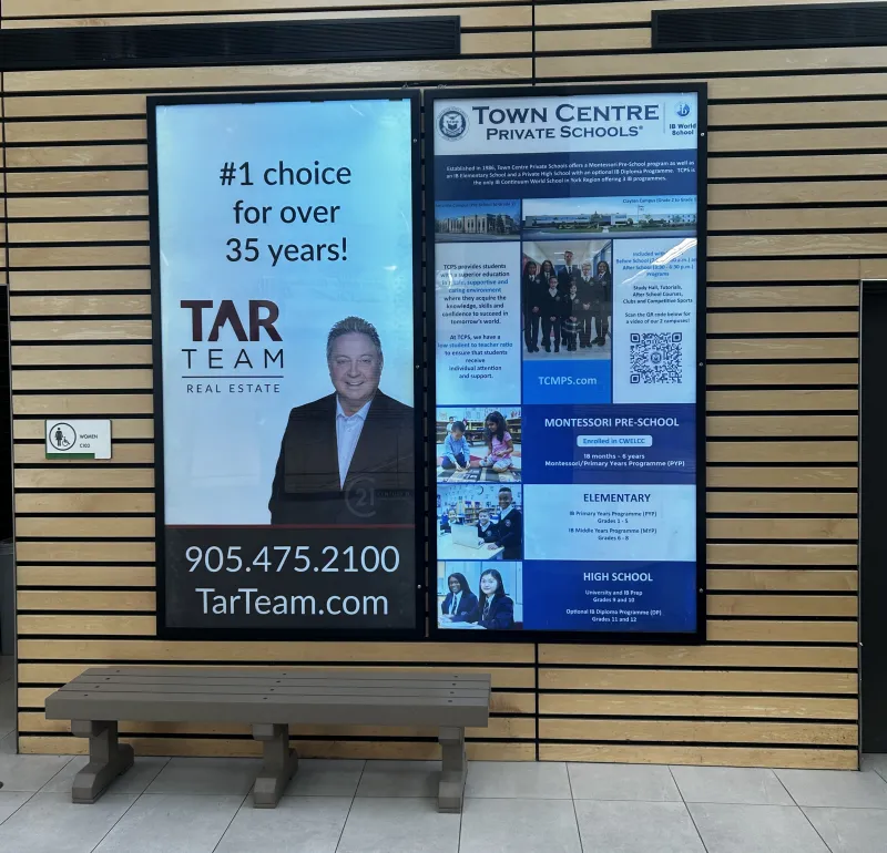 2 backlit ads on a wall.